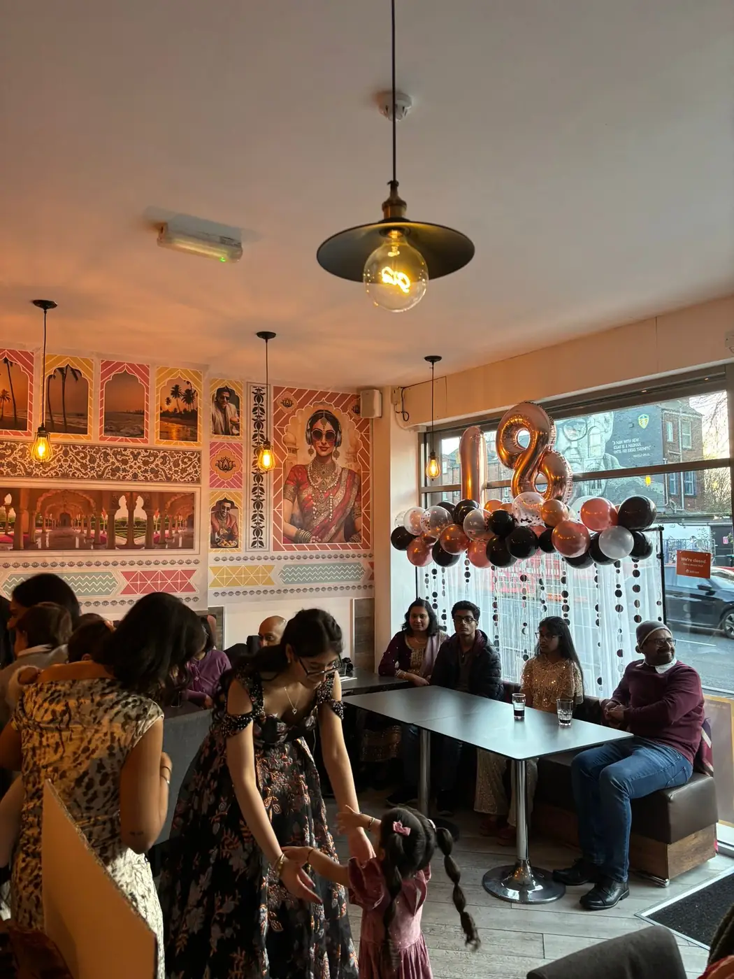 Guests dining beneath the Bollywood murals at Bombay 2 Goa